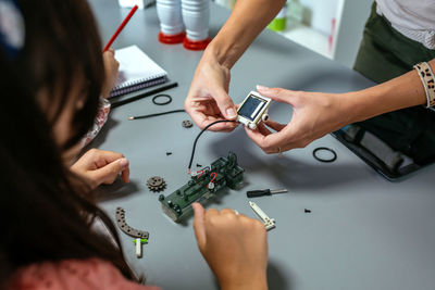 Midsection of man working on table