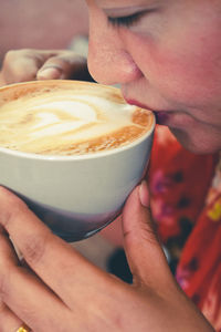 Close-up of woman holding coffee