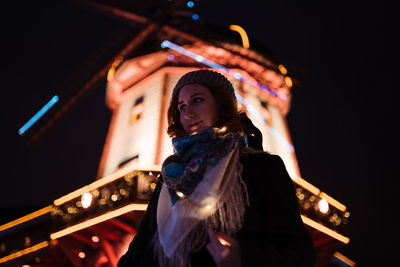 Low angle view of woman standing at night