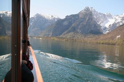 Scenic view of lake by mountains against sky