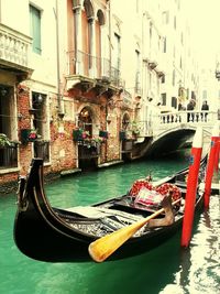 Boats in canal with buildings in background