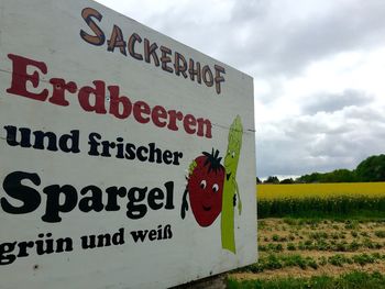 Information sign on field against clear sky