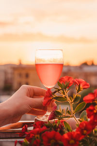 Close-up of hand holding glass of red wine