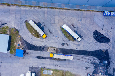 Aerial top view of white semi truck with cargo trailer parking