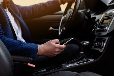 Cropped hand of man repairing car