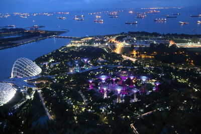 Aerial view of illuminated city against sky at night