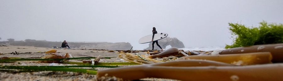 Low section of woman holding umbrella