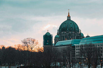 Church by building against sky