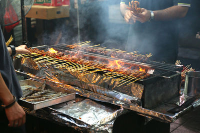 Man working on barbecue grill