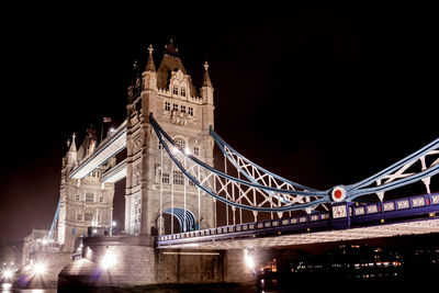 Low angle view of suspension bridge at night