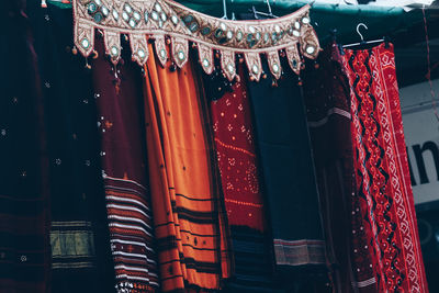 Close-up of clothes hanging in market stall