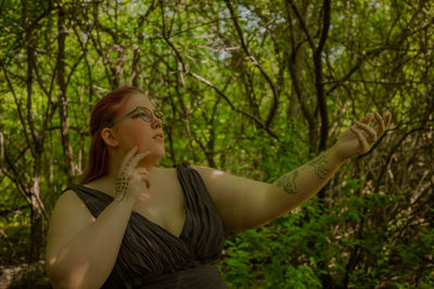 Side view of young woman holding hands