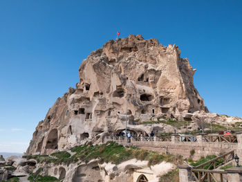 Low angle view of rock formations against sky