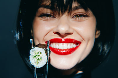 Close-up portrait of young woman eating food