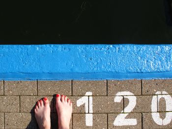 Low section of woman standing on tiled floor