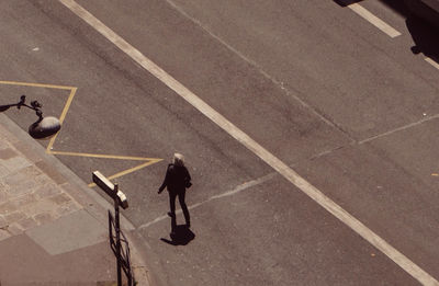 High angle view of man standing on road