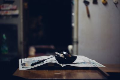 Close-up of spoon on paper at table