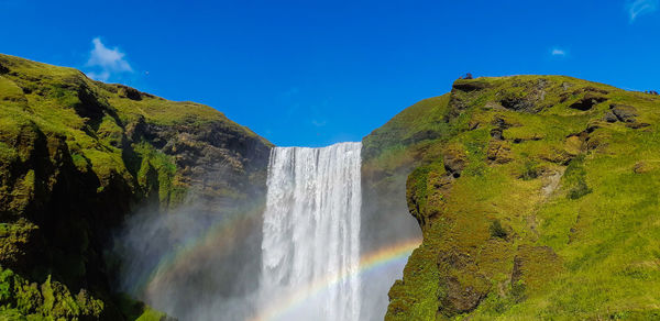 Scenic view of waterfall against sky