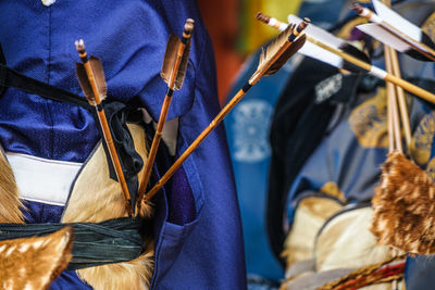 Close-up of person holding blue umbrella