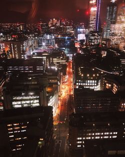 High angle view of illuminated buildings in city at night