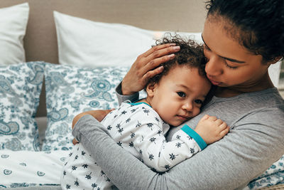 Mother embracing son at home