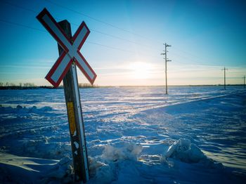 Scenic view of snow covered land against sky