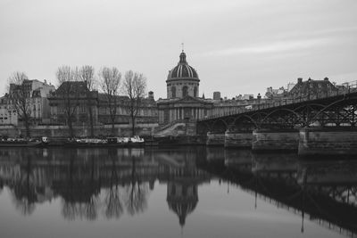 Pont des arts over seine river against clear sky at dusk