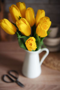 Beautiful yellow tulip flowers on table at kitchen