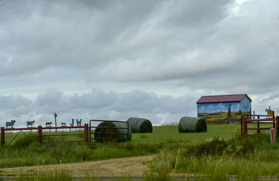 Built structure on field against sky