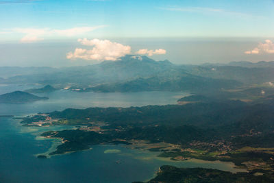 Aerial view of sea and mountains against sky