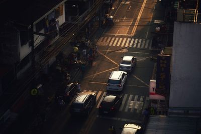 High angle view of vehicles on road along buildings