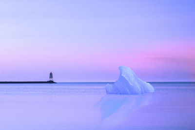 Scenic view of sea against blue sky