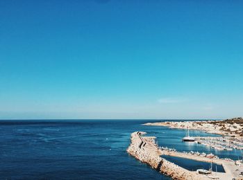 Scenic view of sea against clear blue sky