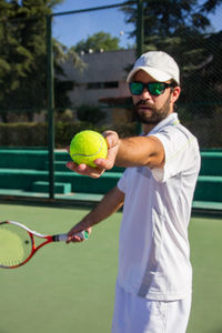 Man playing tennis on court