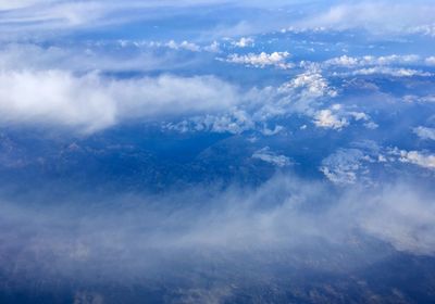 Aerial view of landscape against blue sky