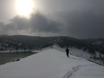 Scenic view of snow covered landscape against sky