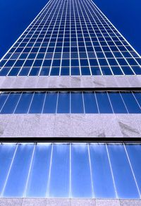 Low angle view of modern building against clear blue sky