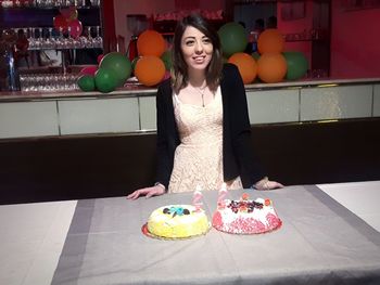 Smiling woman with chocolate cake