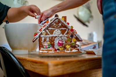 Midsection of person preparing food on cutting board