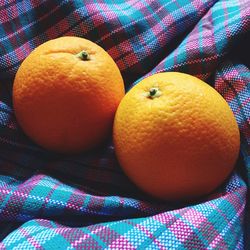 Close-up of oranges on fabric