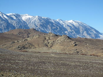 Scenic view of snowcapped mountains against clear sky