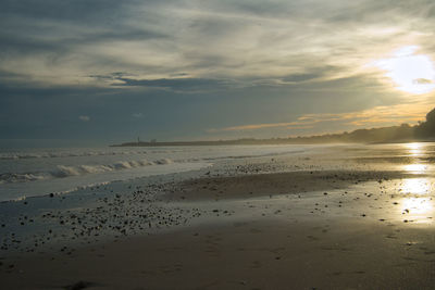 Scenic view of beach against sky during sunset