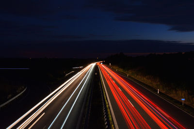 High angle view of light trails on road at night