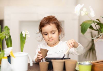 Young woman using mobile phone at home