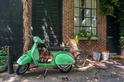 Bicycle parked against building in city