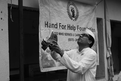 Side view of man working on street