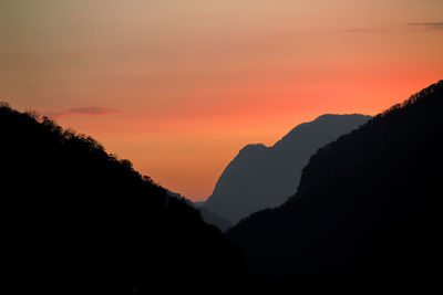 Scenic view of silhouette mountains against sky at sunset