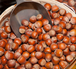 High angle view of hazelnuts with serving scoop in bucket at store