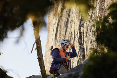 Young man rock climbing