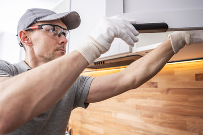 Side view of man working in gym